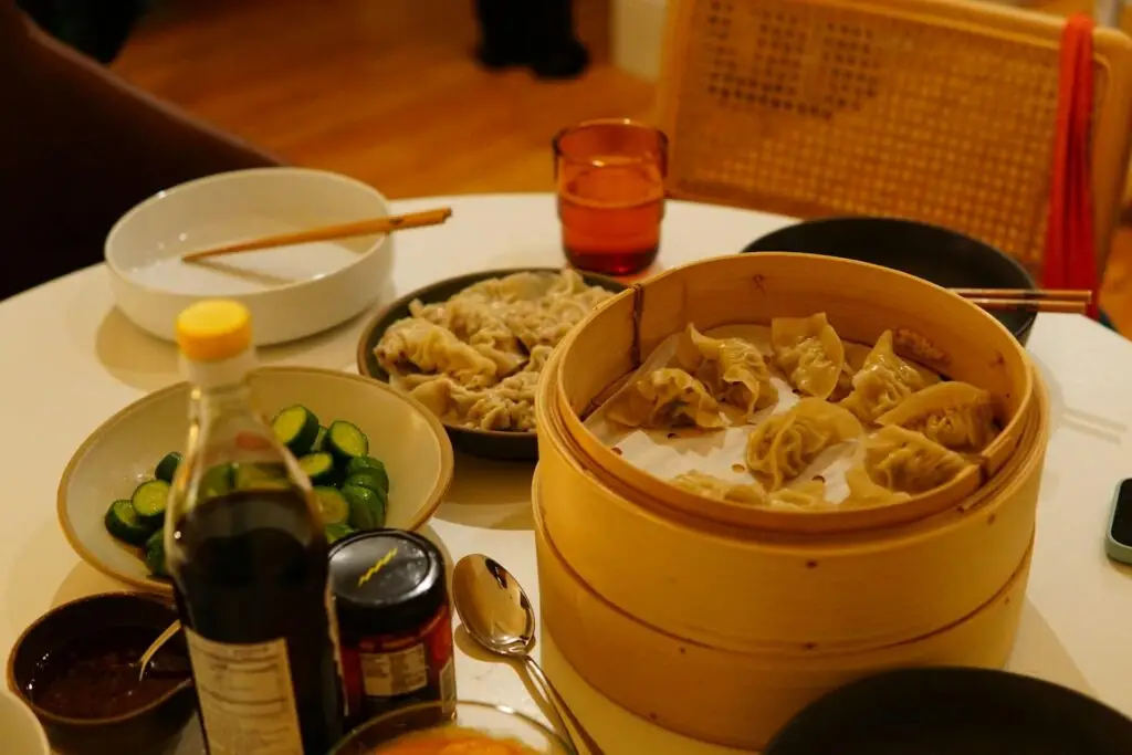Traditional jiaozi dumplings in a bamboo steamer during the Chinese New Year dinner